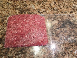 Flatten the sausage / beef and cut the bag open