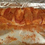 The tenderloin is all snuggled up inside the cozy bacon blanket